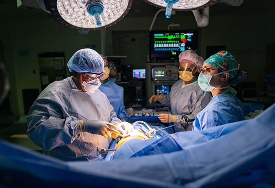 Surgeons performing lung cancer surgery on patient.