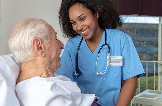 Male patient talking to female health care provider before pain neurosurgery.
