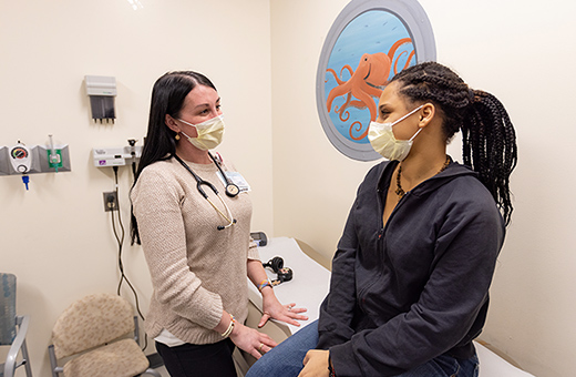 Pediatric patient talking to her doctor