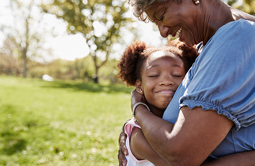 Young girl hugging her grandmother.