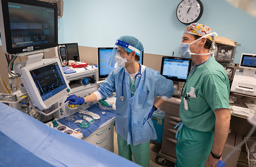 Anesthesiologists monitoring patient during peripheral nerve surgery.
