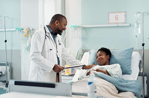 Health care professional talking with patient after pituitary tumor surgery.