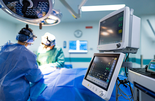 Plastic surgeons working on patient in operating room.