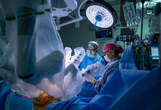 Surgeons using robotic surgery techniques on patient.