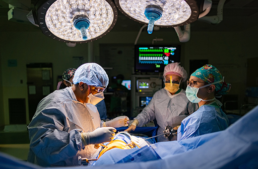 Cancer surgeon performing surgery on patient.