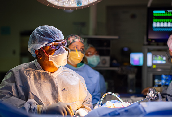 Cancer surgeon working on patient in surgery room.