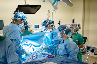 Surgeons performing surgery on a patient