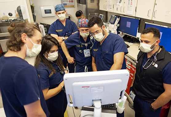 Group of ED physicians looking at computer