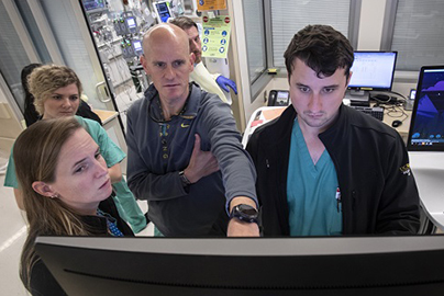 Physicians looking at a computer