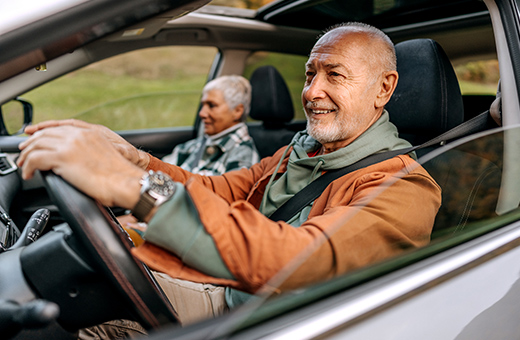 Two people driving in a car to vascular surgery.
