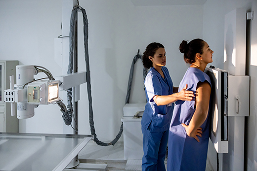 Technician positioning a patient for an X-ray