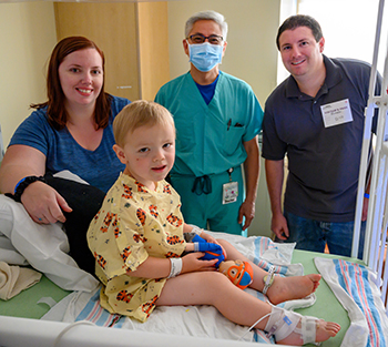 Owen Rinek with his mom Bobbie, Frank Ing and dad Joe.