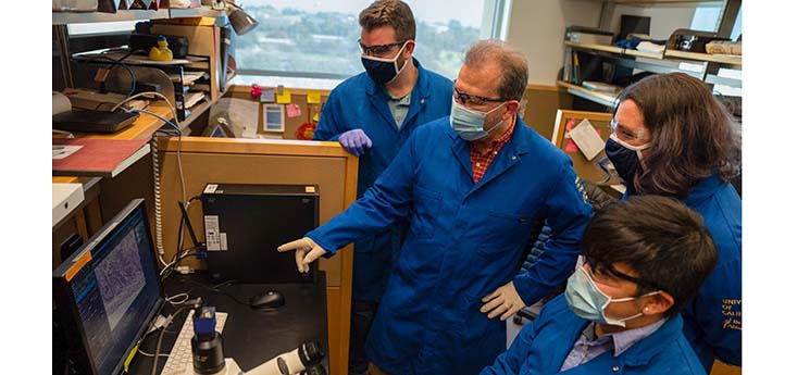 Andreas Bäumler with three of his laboratory members