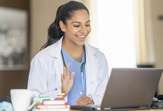 Doctor looking at computer for a telehealth visit.