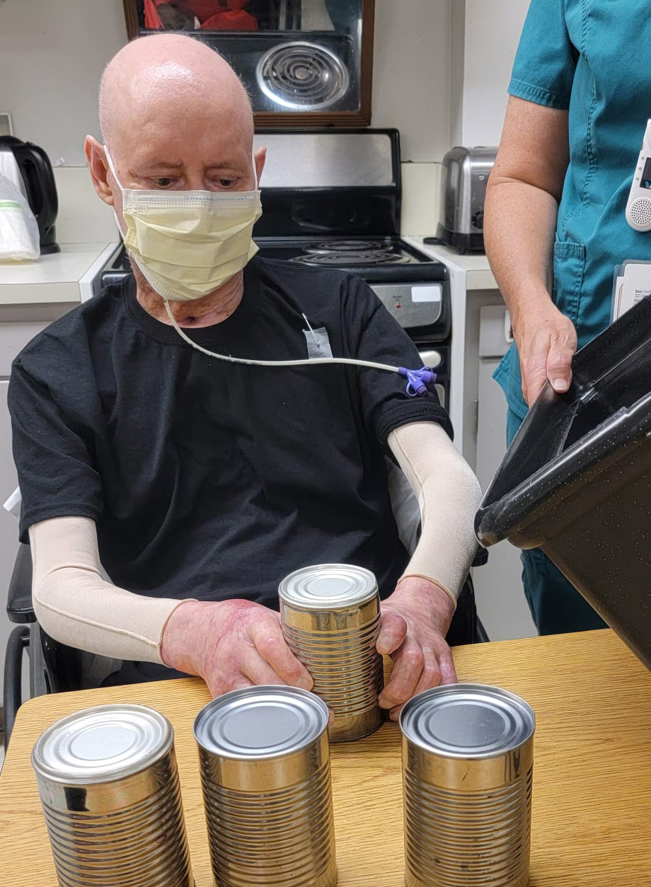 Guadalupe Fonseco works with cans in physical therapy