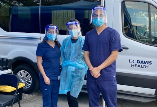 Casey Castro, Angelica Pérez and Conrad Preciado provide COVID-19 testing in a pop-up tent in Knights Landing