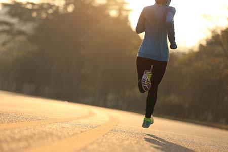 Woman runs on a track.