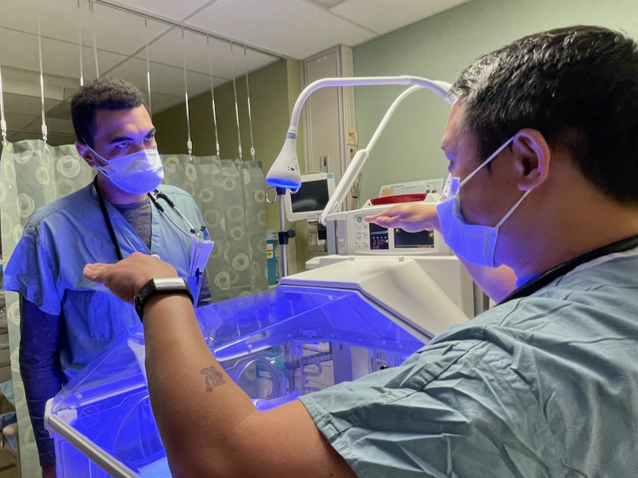 Medical student Benjamin Vincent stands at a newborn incubator while speaking with pediatrician Marcial Salvador at Kaiser Permanente Modesto Medical Center