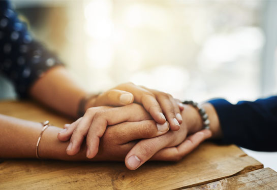 Two black hands holding each other