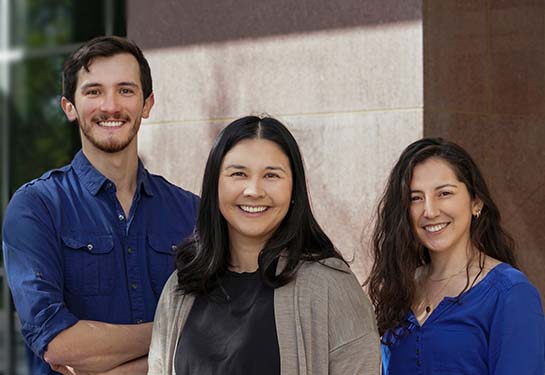 Assistant Professor Megan Dennis and graduate students Colin Shew and Daniela Soto stand outside the UC Davis Genome Center.