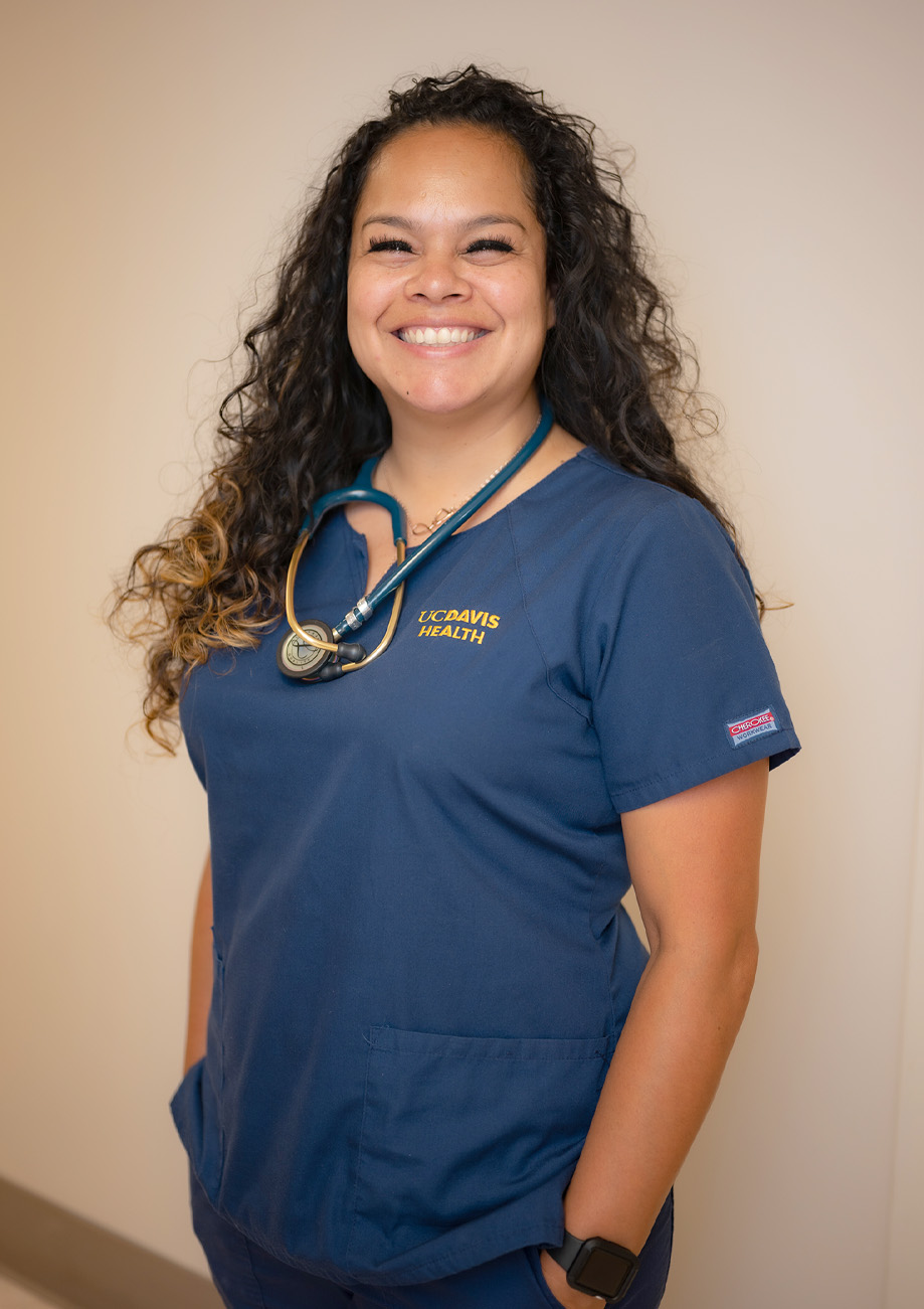 Irene Cisneros-Fong standing wearing scrubs