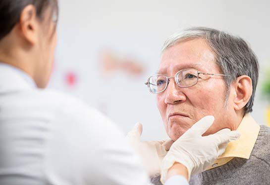 Man having throat examined