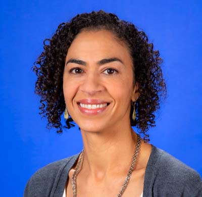 Susan Brown wearing a white shirt and blue sweater