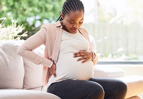 Pregnant woman holding her stomach