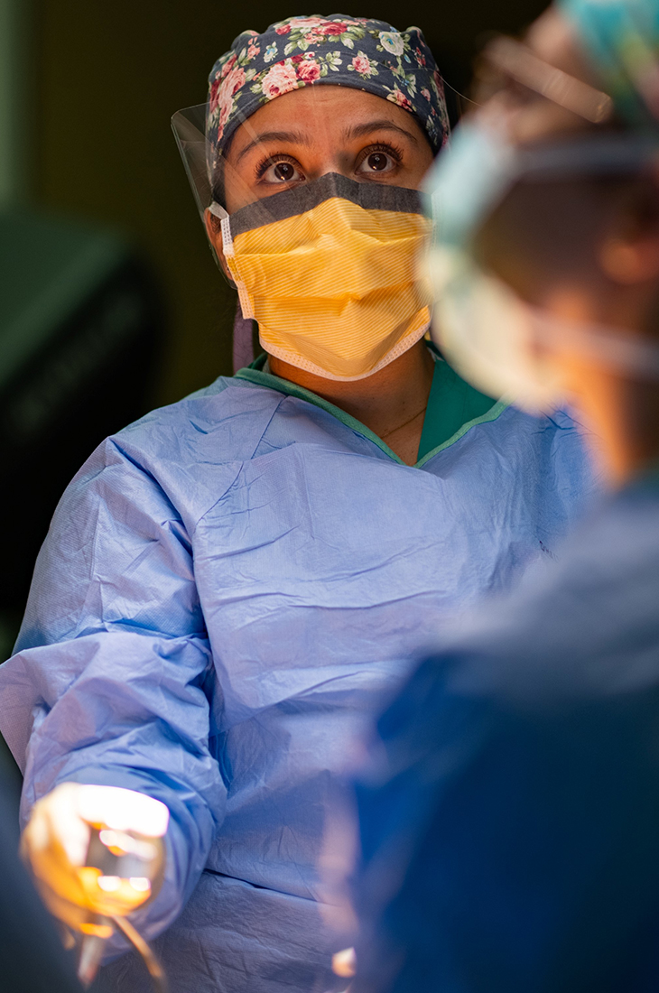 Angelica Martin, in medical scrubs, stands at the operating table before a thoracic surgery procedure at UC Davis Medical Center