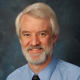 Donald Bers wearing a blue shirt and tie