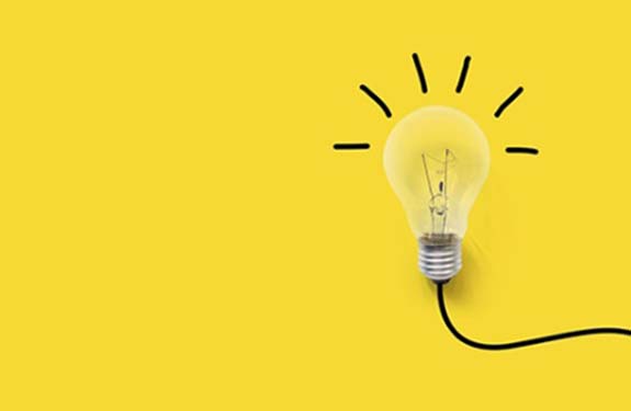 Stock lightbulb on yellow background