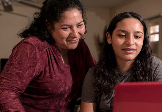 Mother and daughter looking at something on a computer