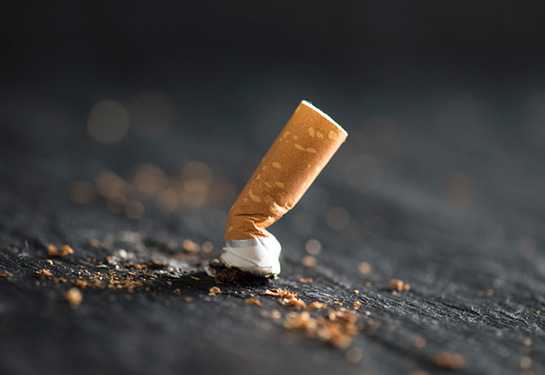 Crushed cigarette on a black background