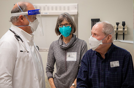 Dr. Joseph Tuscano meeting with oncology patient and his wife as part of a clinical trial for the CAR T therapy