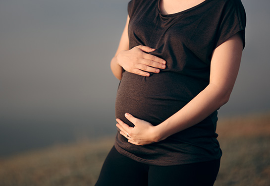 Pregnant mother holding her belly