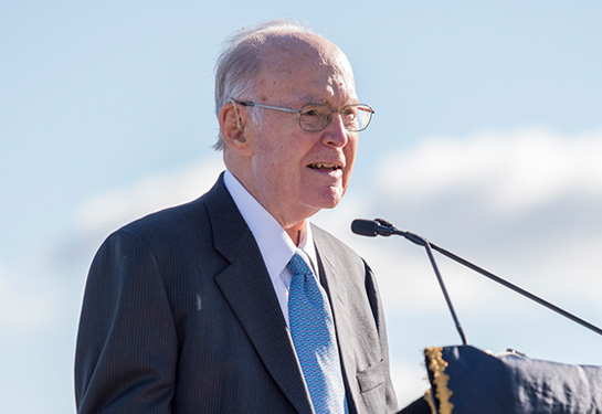 Gordon Moore stands at podium speaking into the microphone