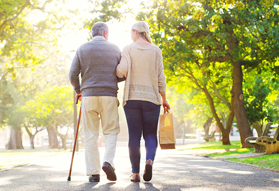 two people walking away from camera