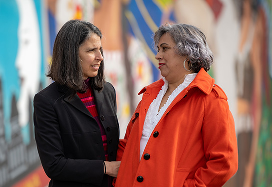 Laura Fejerman walking with promotora