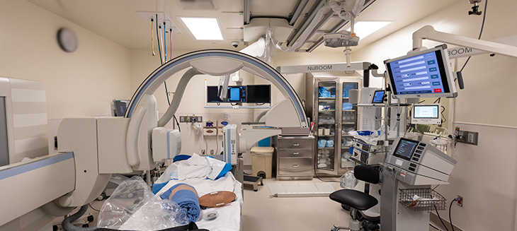 Hospital room with patient bed, computer and robotic devices