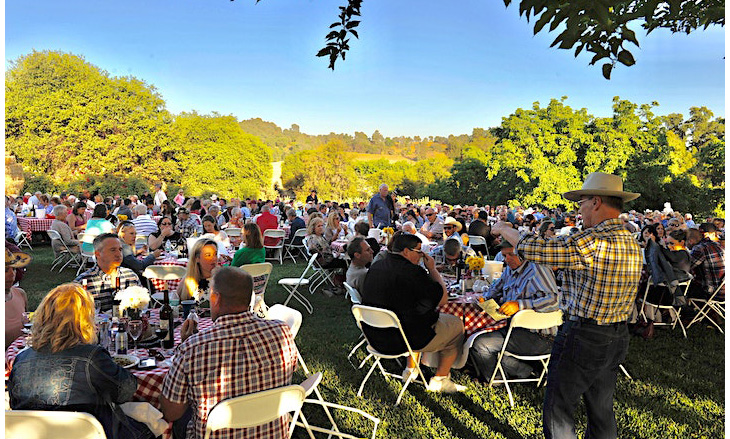 Attendees sitting at tables outside