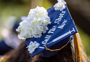 Mortar board decorated with syringe and the words: I call the shots now