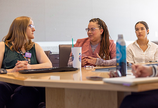 Three women talking at a table