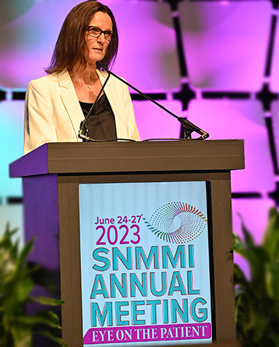 Julie Sutcliffe at a podium after accepting award