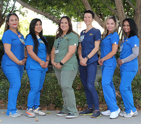 Group of LEAD clinic navigators in front of a tree