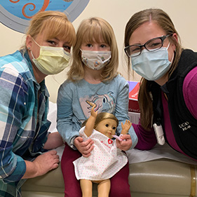 Dianna Cooley and Mackenzi Lee with Peyton between them