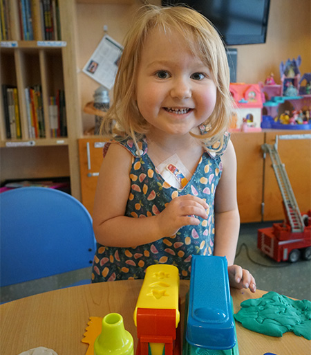 Peyton playing with toys on a desk