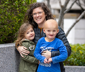 A person with two children posing for a photo.