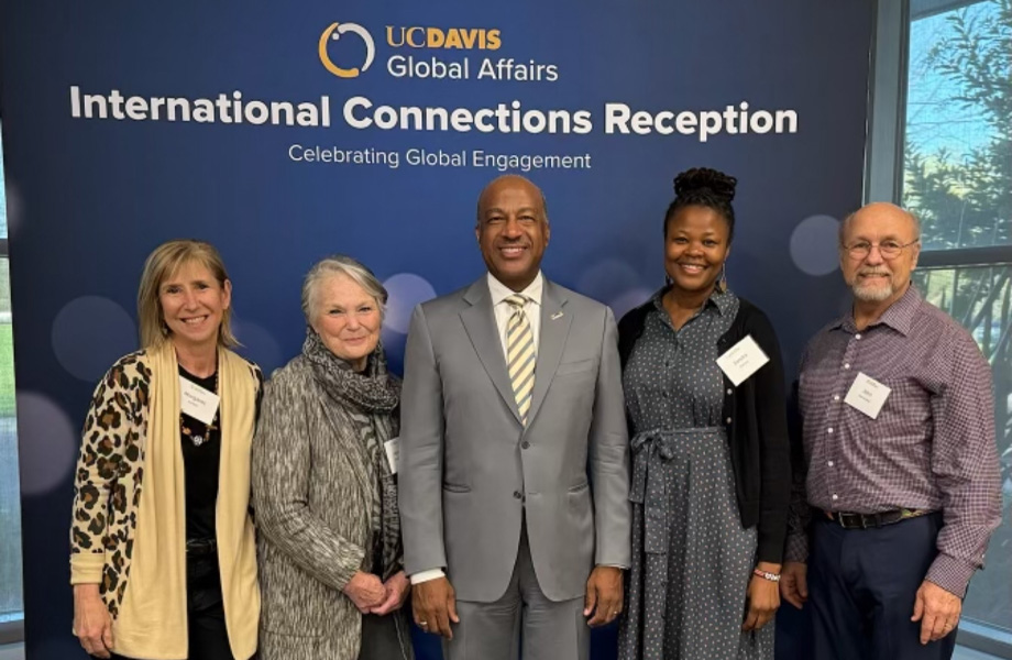 Members of Kenyan outreach team pose side-by-side in front of sign that reads International Connections