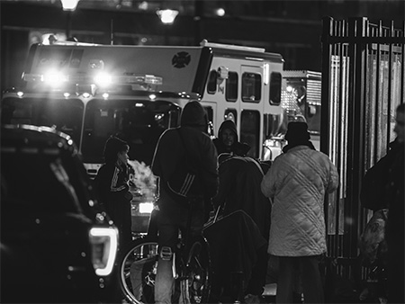 Black and white photo of people around emergency vehicles