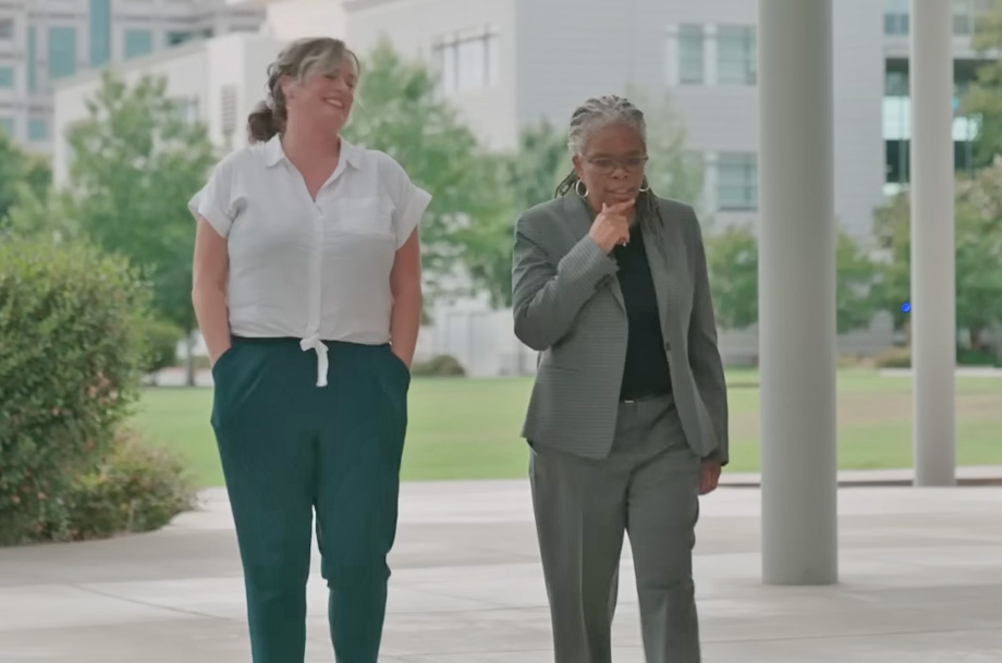 Two women walk outdoors in scene from the film